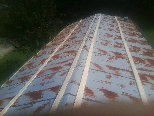 Rusted metal roof panels with new wood purlins before replacement — Storm Damage Roof Repair in Mount Wolf by Roofing Brothers