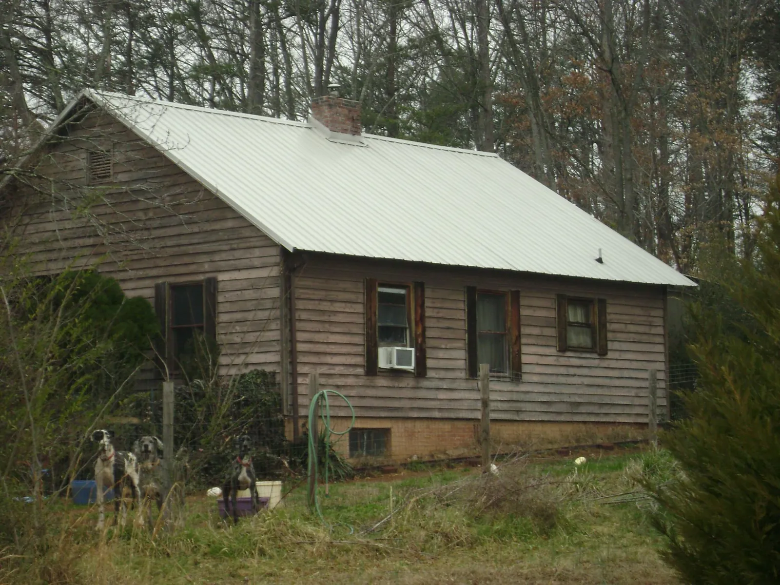 White metal roof on an old wood sided farmhouse, from a Metal Roof Installation job in Mount Wolf